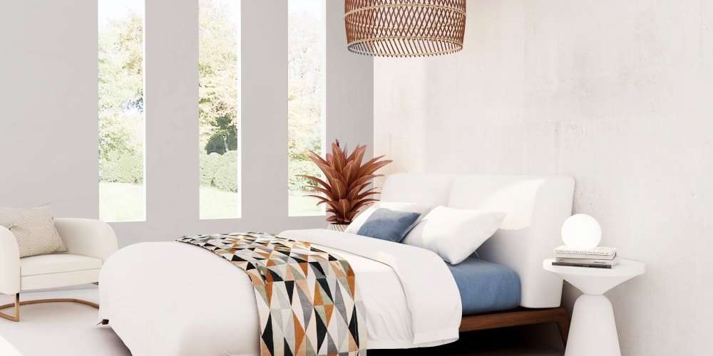 White bed in a bedroom with white walls and carpet from Carpet Planet in Colorado Springs, CO